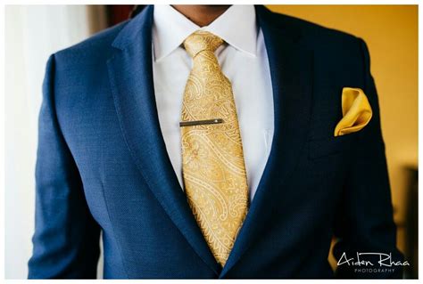 navy blue suit gold tie.